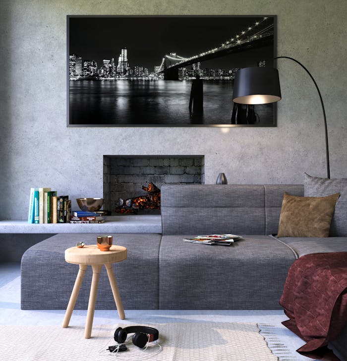 our-services-3 Modern gray living room featuring a fireplace and cityscape artwork, creating a cozy ambiance.